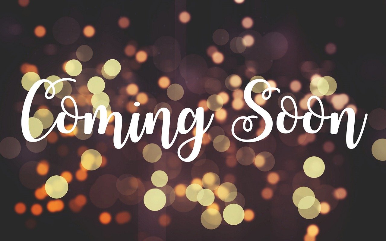 coming soon text with blurred lights behind the words